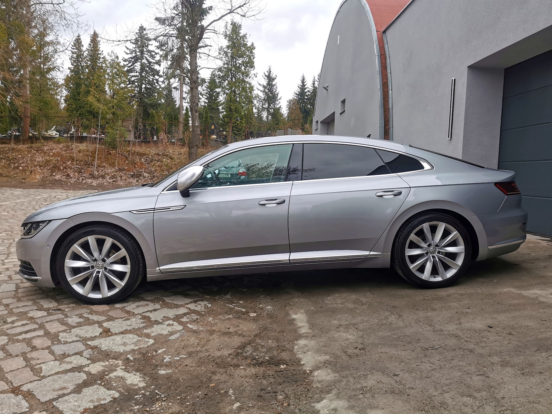 Srebrne Volkswagen Arteon z odbiciami w wypolerowanym boku